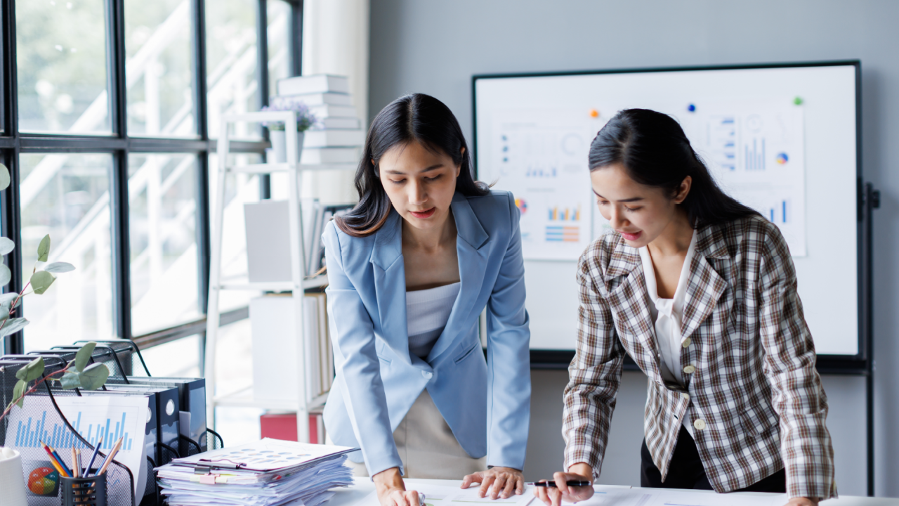 Two financial professionals reviewing documents to compare CPA vs accountant services
