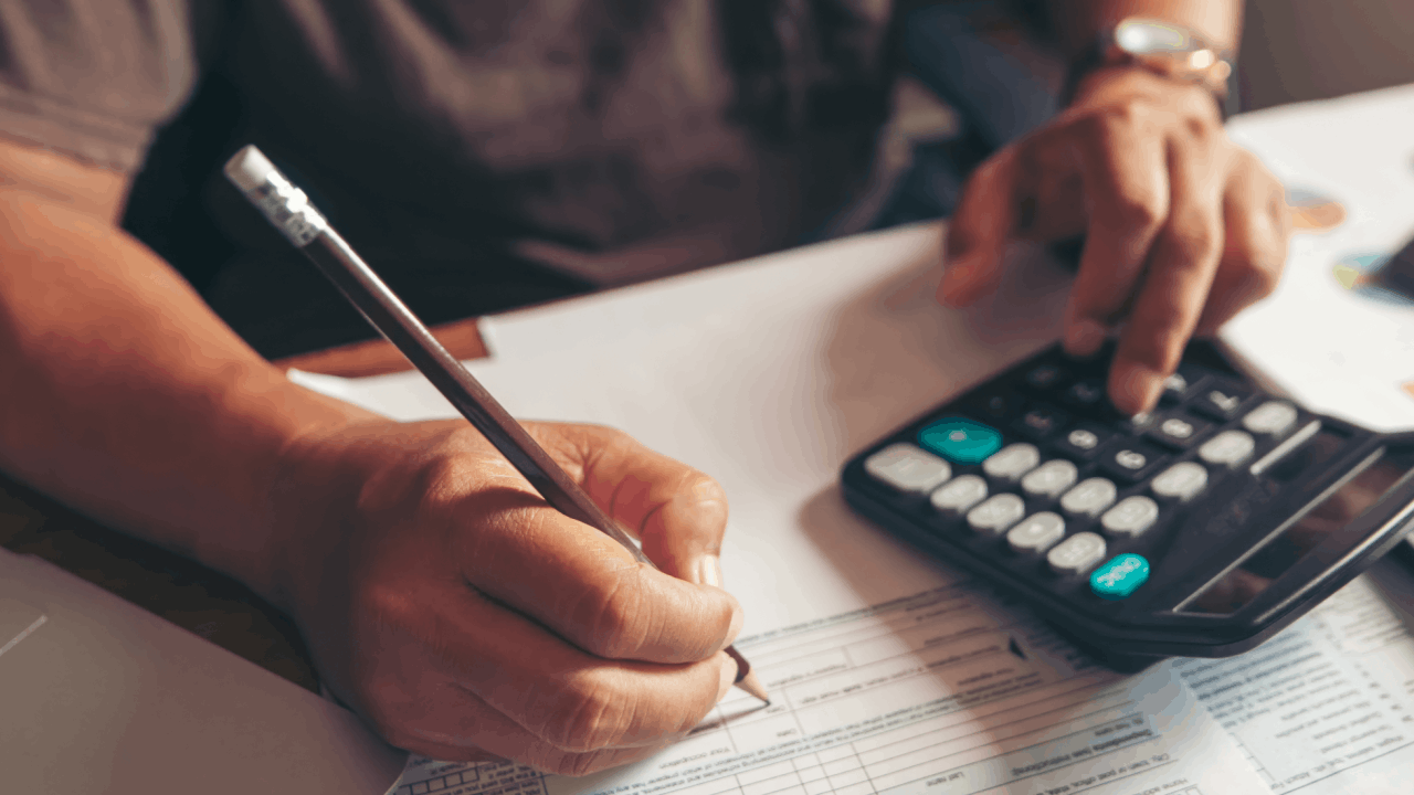 Person reviewing financial advisor cost documents with a calculator