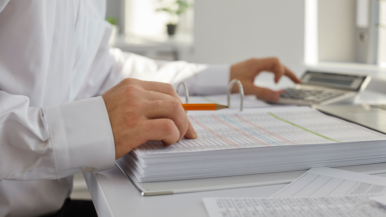 when to hire a bookkeeper — professional reviewing financial records
