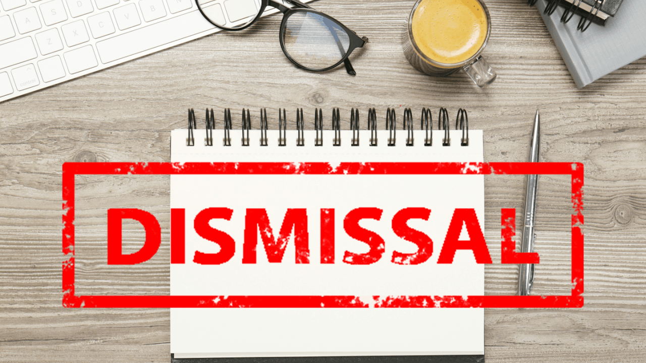 Wrongful termination case dismissal notice on office desk