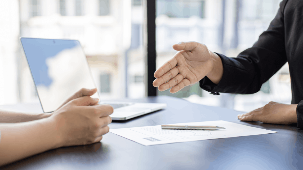 Wrongful Termination Laws discussion between attorney and client across office desk with documents