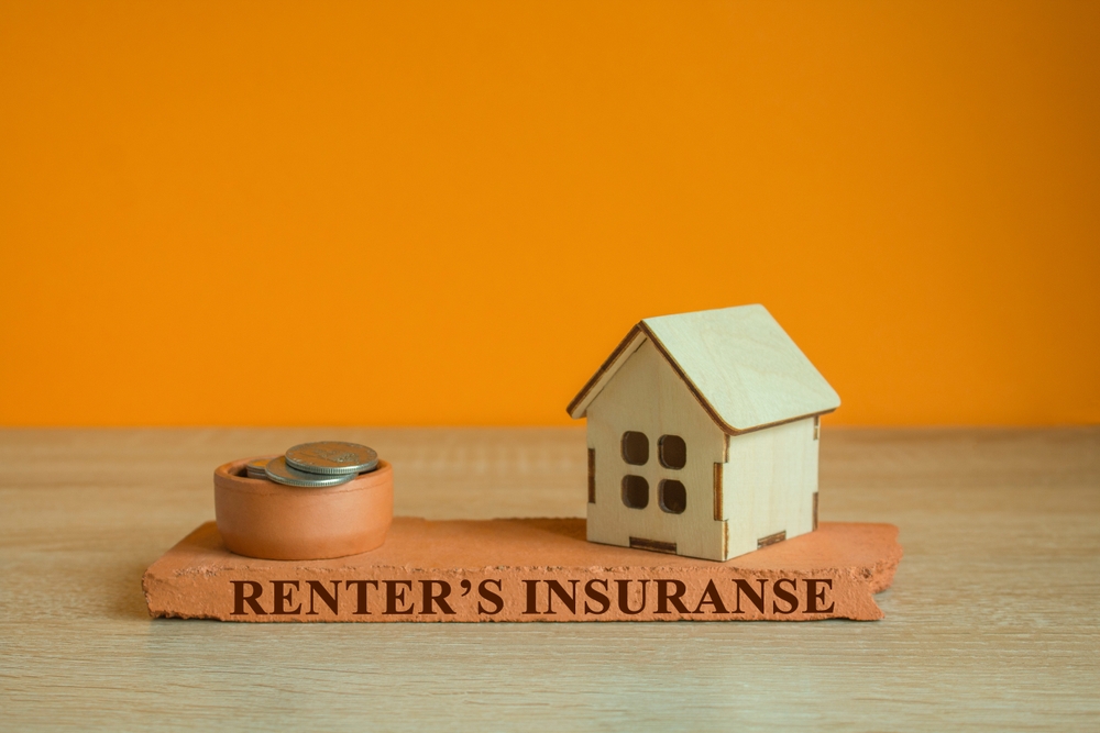 What Affects Your Renters Insurance Quote? | The word RENTER'S INSURANCE is written on brick block. Beautiful orange background.